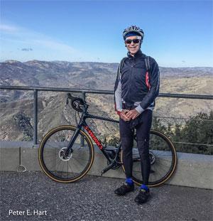 Peter E. Hart with a bicycle overlooking a landscape